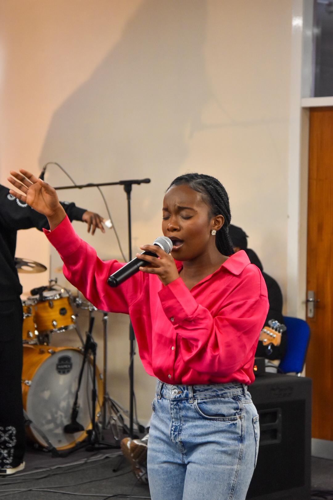 Worship leader singing at a gathering