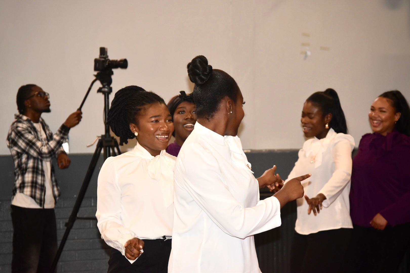 Women celebrating together at a She Will Do Exploits gathering